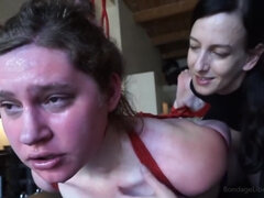 Submissive girl is put into tight bondage by a mistress