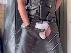 Man in leather glove jerks off big cock solo
