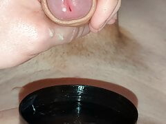 Quick close up uncut oily wank and cum into container