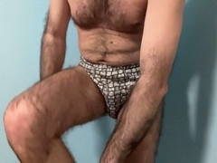 Hairy bear Earl Smile shows off his impressive cock and balls while gliding in underwear