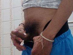 Guy gives himself a handjob in the bathroom with his big cock