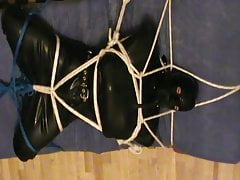Boot to face - restrained rubberslave in the hogsack