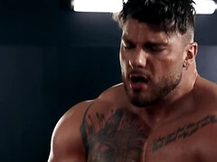 Muscular bear with tattoos receives a blowjob from a twink