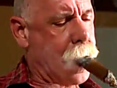 Scott Reynolds smokes a cigar while playing with his cock