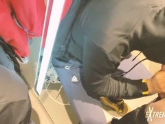 Horny young men blow each other in the fitting room