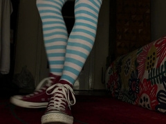 Femboy dressed in Chat, hip high socks and demonstrating nude soles