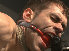 Gagged man sits restrained in roped and endures anal in merciless positions