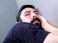 Bearded milky guy inhaling and fucking a black cock at a gloryhole