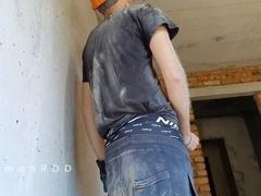 Determined builder drains his load while enjoying a smoke outdoors