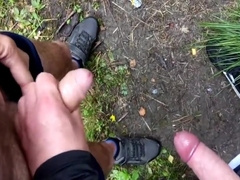 two men masturbating down the forest