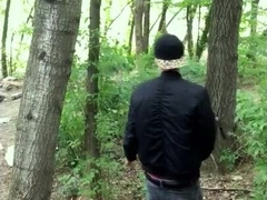 Bad guy strokes while smoking ciggy in a woods - nearly caught - so his scrotum linger utter