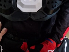 Fellow screws another man in a motocross attire