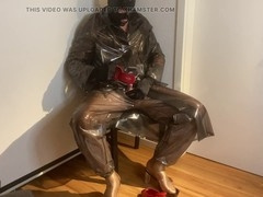 Crossdresser in red mules indulges in plastic fetish attire while getting jizzed on