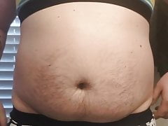 Chubby boy in a bra rubbing his cock with clamps