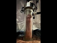 Milking machine sucks and stretches cock