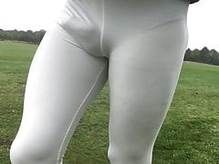 Walking in a public park in white leggings.