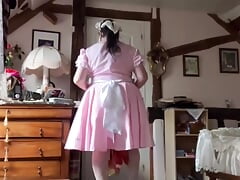 In a pink and white maid's outfit