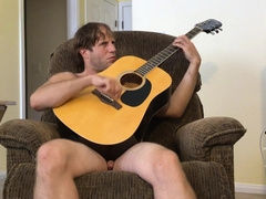 Bare Unshaved Dude Guitar Toying