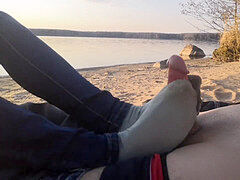 public footjob and socksjob on the beach