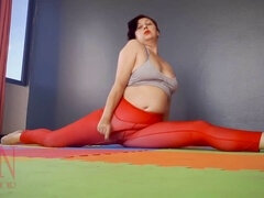 Regina Noir, the seductive doll, practices yoga in the gym wearing a revealing red leotard.