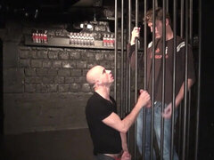 He is caged but he still manages to receive a blowjob