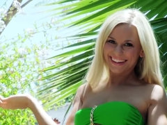 A blonde is enjoying the warm weather by rubbing her pussy in the garden