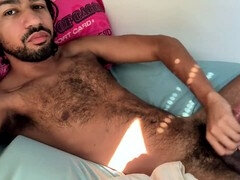 Mishaun enjoys some solo fun with his big, hairy cock and moans in bed
