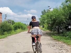 Follow the kitten cyclist who rides without panties under her skirt
