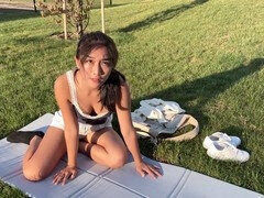 Horny babe plays with sex toy in public park