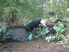 Busty Samantha gets very dirty outdoors in pool of mud