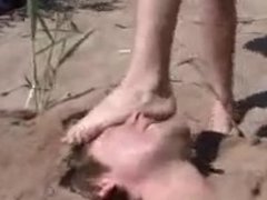 Slave gets feet trampling & humiliation on the beach by 2 mistresses