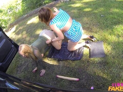 Wild lesbian babes share a massive dildo in a car for a wild 69 ride