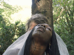 Black bride and a white groom are having sex in the woods