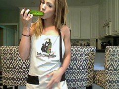 Teen having fun with a cucumber