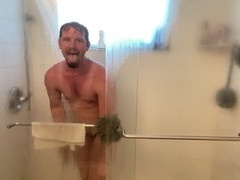 man showers and shows his big cock