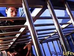 Young man in cage enjoys having large cock up his ass