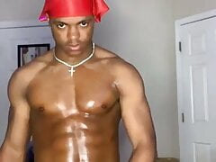 A muscular black gay man jerks off a big Dick at home