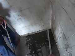 Two friends pissing in the parking garage