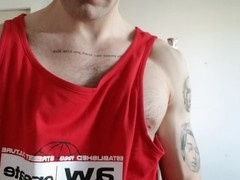 Gay hunk with uncut dick, hairy chest, and toned muscles