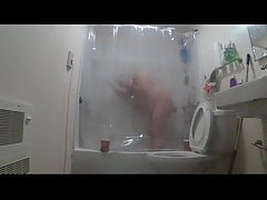 taking a shower through clear curtain