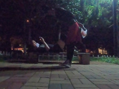 Fellow in black silk tempts passers-by on the side of the road for sucky-sucky bang-out