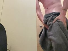 In the public showers of a campground with an erection and a little pee