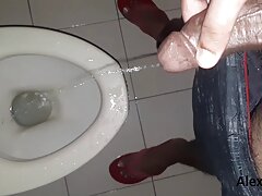 Horny guy pissing in the toilet