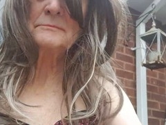 Mature woman flaunts lingerie outdoors