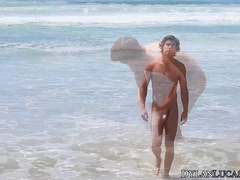 Naked butt Owen jerks off his cock by the beach