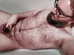 Hairy locked bear pissing in chastity