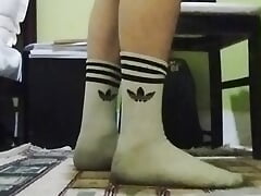 Cute twink showing his dirty white socks, while he listening to music and singing.
