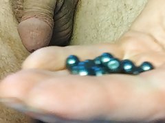 Cock stuffed with 35 beads then piss P1