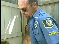 Muscular man in uniform and wearing glasses sucks and blows