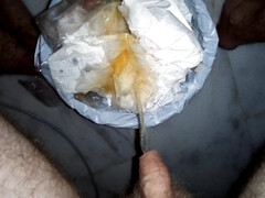 John is waking up and Pissing into the Trashcan